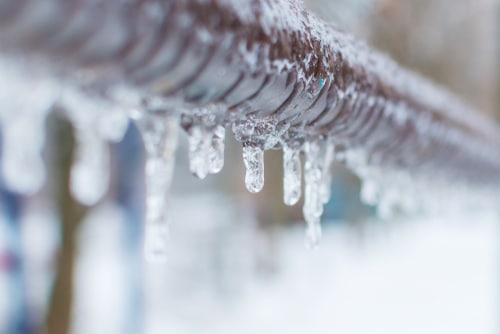 Frozen Icicles After Rain On The Pipe