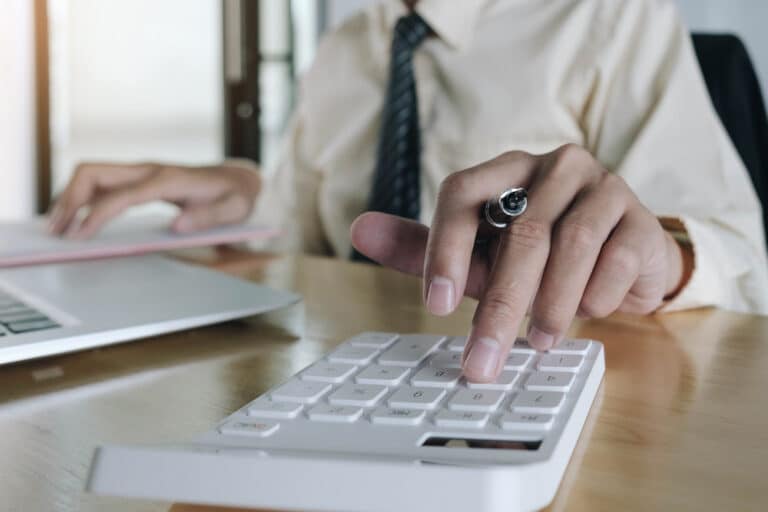Close Up Business Woman Using Calculator And Laptop