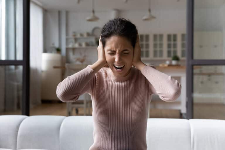 Woman covering her ears