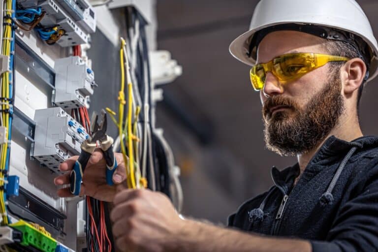 Male Electrician Works In A Switchboard