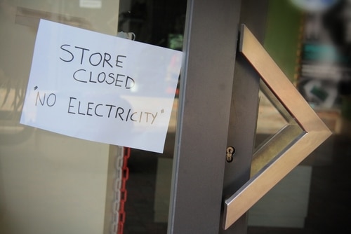 Sign posted on glass store closed no electricity