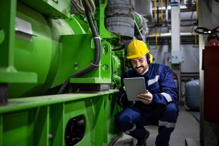 Worker Or Serviceman Checking Diagnostics Of Large Industrial Generator