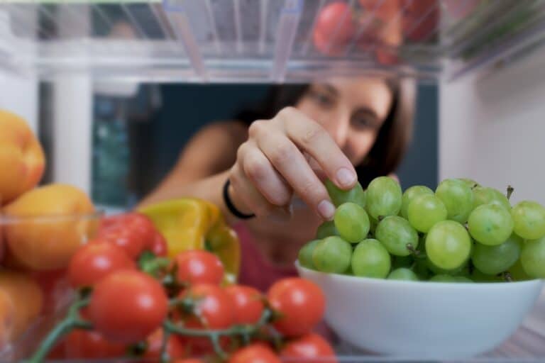 Young Woman Having A Healthy Snack She Is Taking Fruit