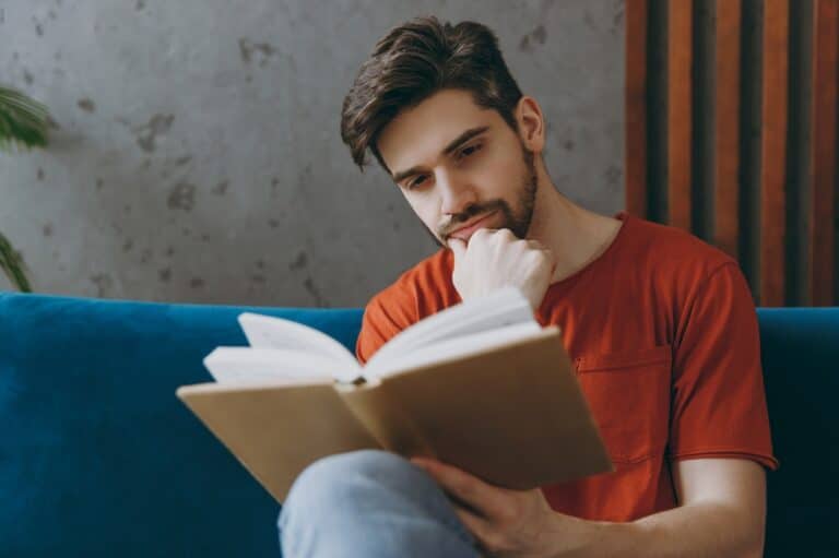 Man on sofa reading a book