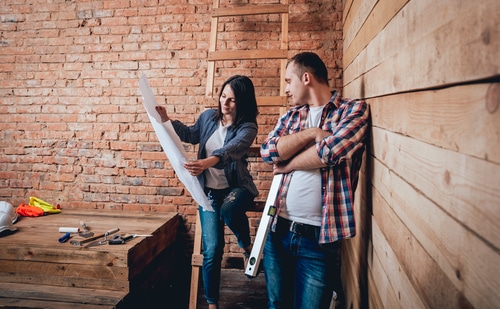 Happy Couple Making Repairs To Their Home